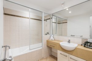 Main bathroom with shower over bath in 2 bedroom apartment North Cove Cairns