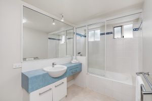 Basin and shower over bath in North Cove Apartments